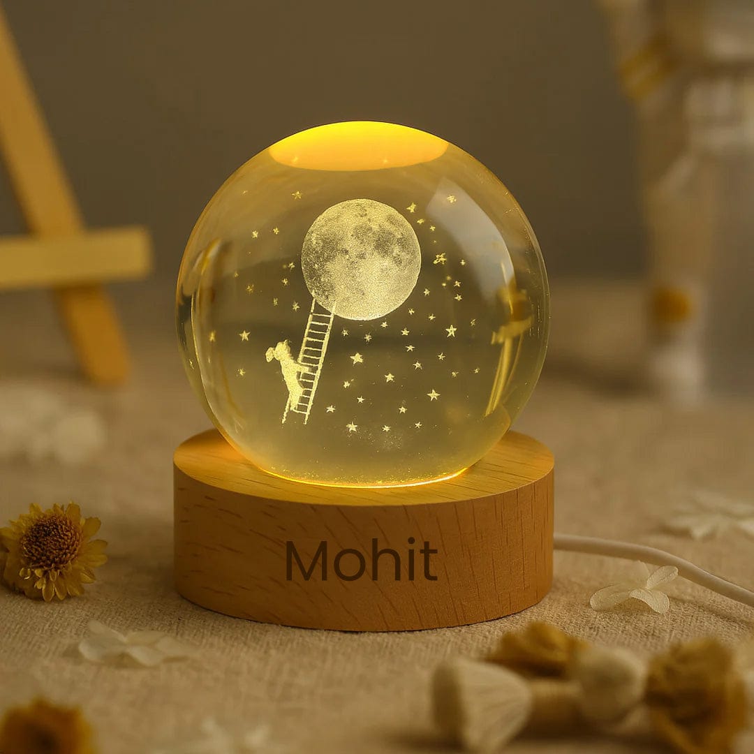 Crystal moon lamp lit with soft yellow LED, engraved with dreamy moon and girl on ladder – personalized base.